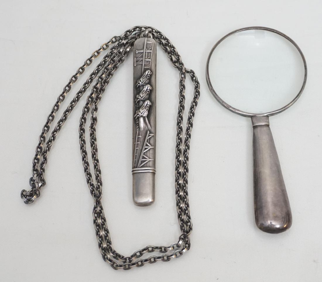 2 ANTIQUE STERLING NEEDLE CASE + MAGNIFYING GLASS: 1- Antique Sterling Silver Needle Case with Racehorse Detail on 30" (opened) Sterling Chain. 2- Celia Sebiri Signed Sterling Magnifying Glass 3 3/4". Weight on all 2.2 oz. PROVENANCE: A Private Charle