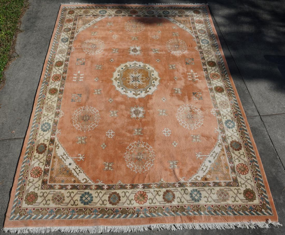 LARGE 14 FT INDO PERSIAN RUG: A large hand woven Rajah Indo-Persian Jaipur room size rug. 14' Ft. x 10' Ft. The wool pile rug features a compound border and woven in palette of peach, ivory, gold, rust, gray and light blue. It has
