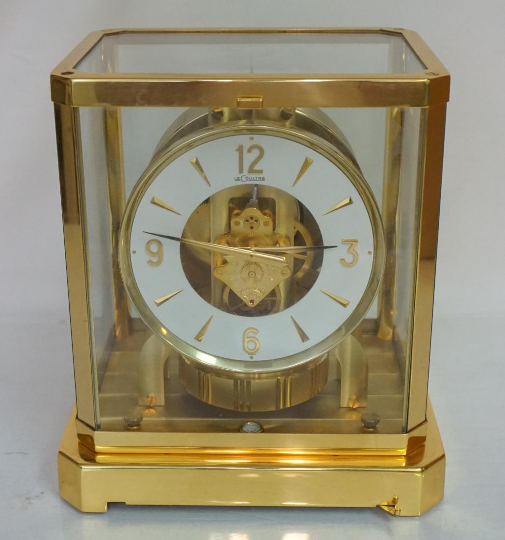 LE COULTRE ATMOS CLOCK MID CENTURY: Mid Century 1960s Jaeger-Le Coultre Atmos 15 jewels perpetual motion gilt brass mantel clock. The clock appears with a glass case, open escapement movement, and bubble level. Driven by a mechanical to