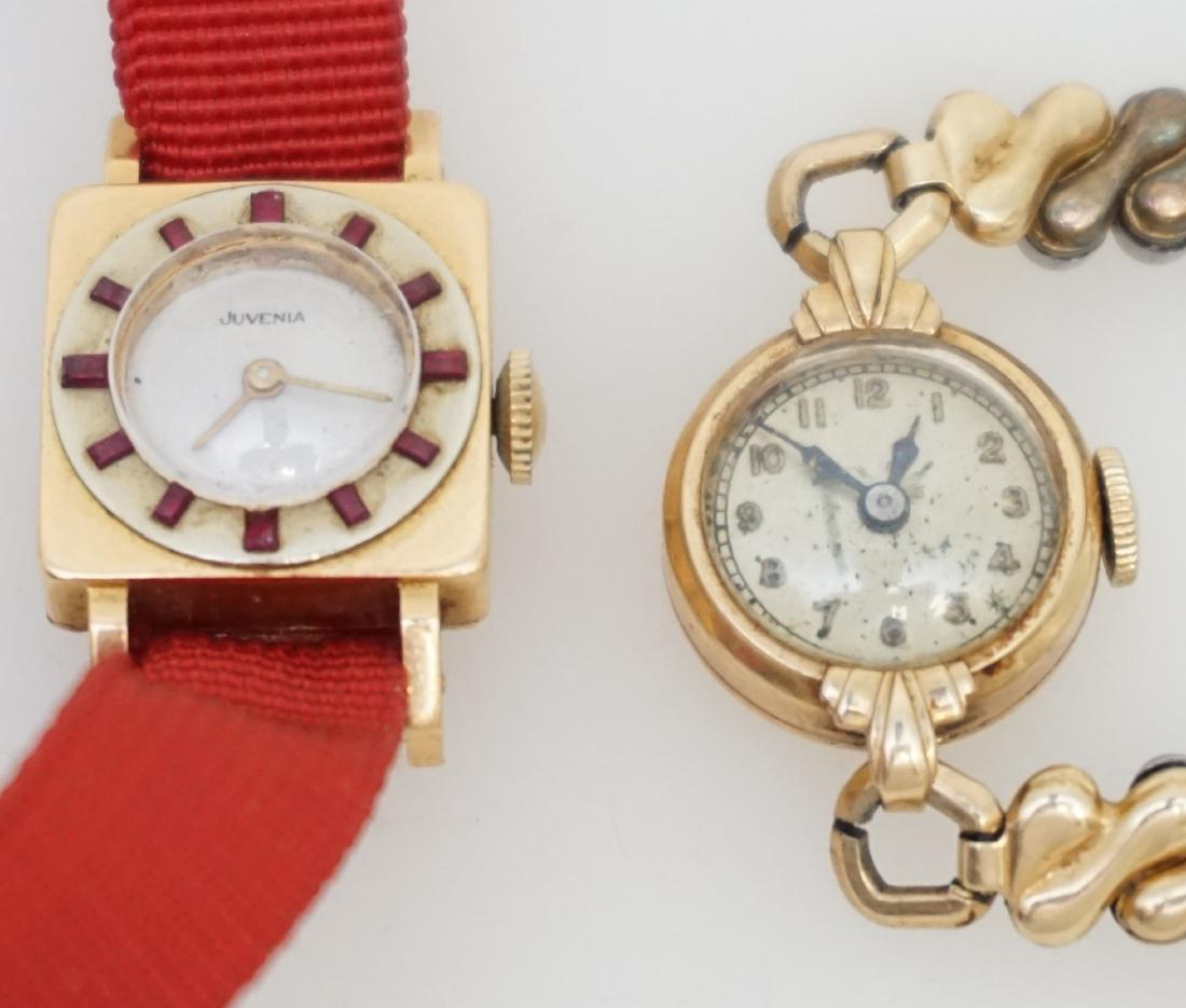 2PC WATCHES- JUVENIA & MORE: Two wrist watches- one 18kt Juvenia, one 14kt gold. The 18kt gold Juvenia watch has a square case with a round face featuring a red stone bezel. the watch measures 16.35mm square, 26.15mm with lugs, a