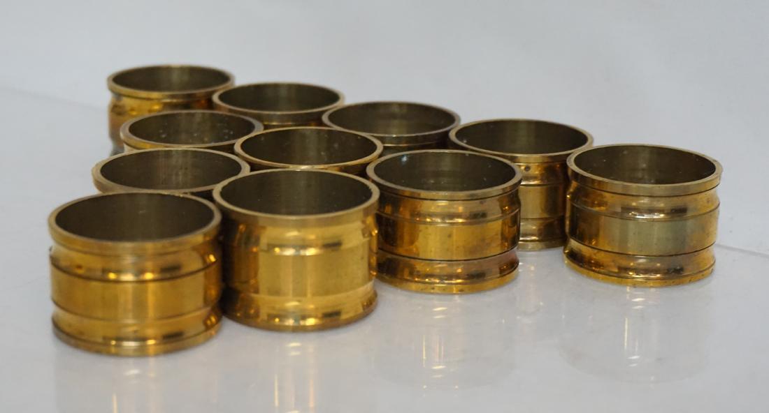 12 MID CENTURY BRASS NAPKIN RINGS: 12 Mid Century Solid Brass Napkin Rings. Each 1 1/2"x1". Weight on all 12.8 oz. PROVENANCE: A Tokyo Japan/ Charleston SC Estate