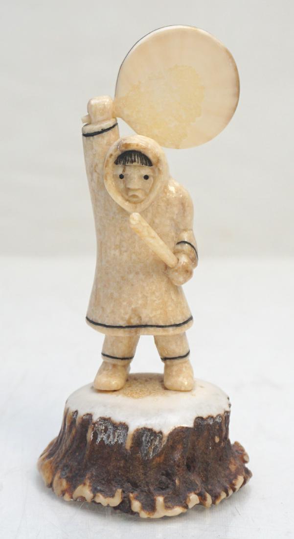 EDDY SYNGOC CARVED FOSSIL WALRUS: Fossil Walru Inuit Drum Dancer carved by Inuit artist, Eddy Syngoc of Alaska. Signed under the base by the artist, carved in 1989. Great details. Measures 2 1/2"x2 1/4"x5 1/2". Weight 5.5 oz. PROVENAN
