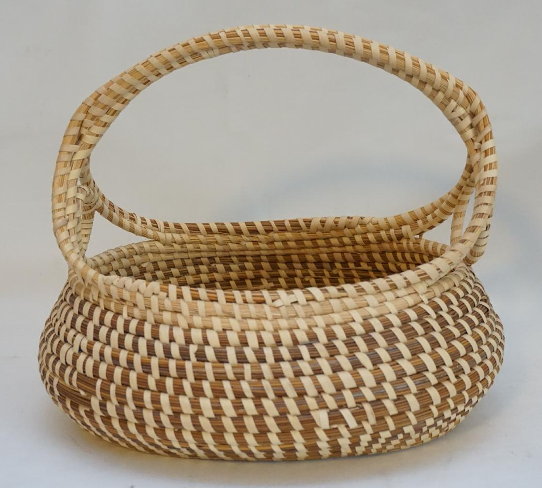 GULLAH SWEETGRASS FRUIT BASKET: Mt. Pleasant South Carolina Gullah lowcountry sweetgrass basket with handle. Measures 12.5 x 9.5 x 11" . Weight 1 pd 2 oz. PROVENANCE: A Private Mt. Pleasant - Old Village SC Estate.