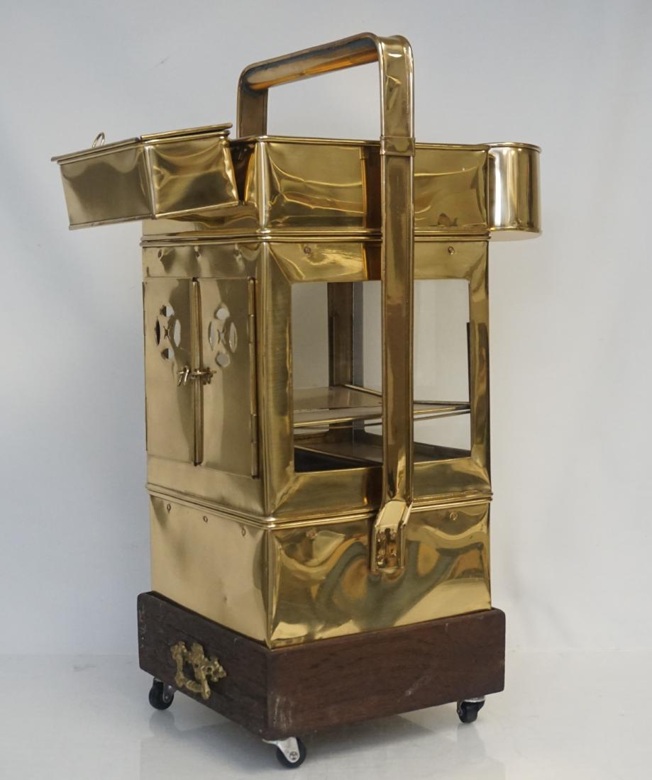 THAILAND VINTAGE BRASS VENDOR CART: Vintage Thai brass noodle cart c. 1920. Traditional street vendor cart from Thailand. Brass with glass panels on teakwood base with wheels and one drawer. Pierced double doors, Brass figural handle on