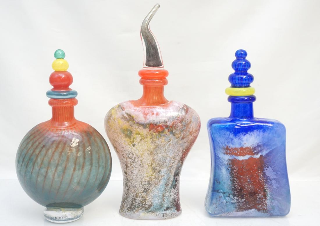 3 KOSTA BODA KJELL ENGMAN DECANTERS: Three Vintage Modernist Kosta Boda Signed and Numbered Decanters by Kjell Engman. Known for his whimsical art glass, Kjell Engman is a swedish glass blower and designer at Kosta Boda. One 13" tall, th