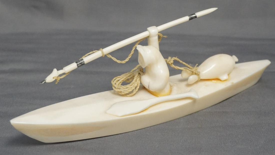 INUIT CARVED KAYAK HUNTER WALRUS FOSSIL: Vintage Hand Carved Inuit Fossilized Walrus "Kayak Hunter". Finely carved. Measures 6 1/2"x1 1/2"x2 1/2". Weight 4.5 oz. Alaskan native collected and carved. It is a natural material and can have vari