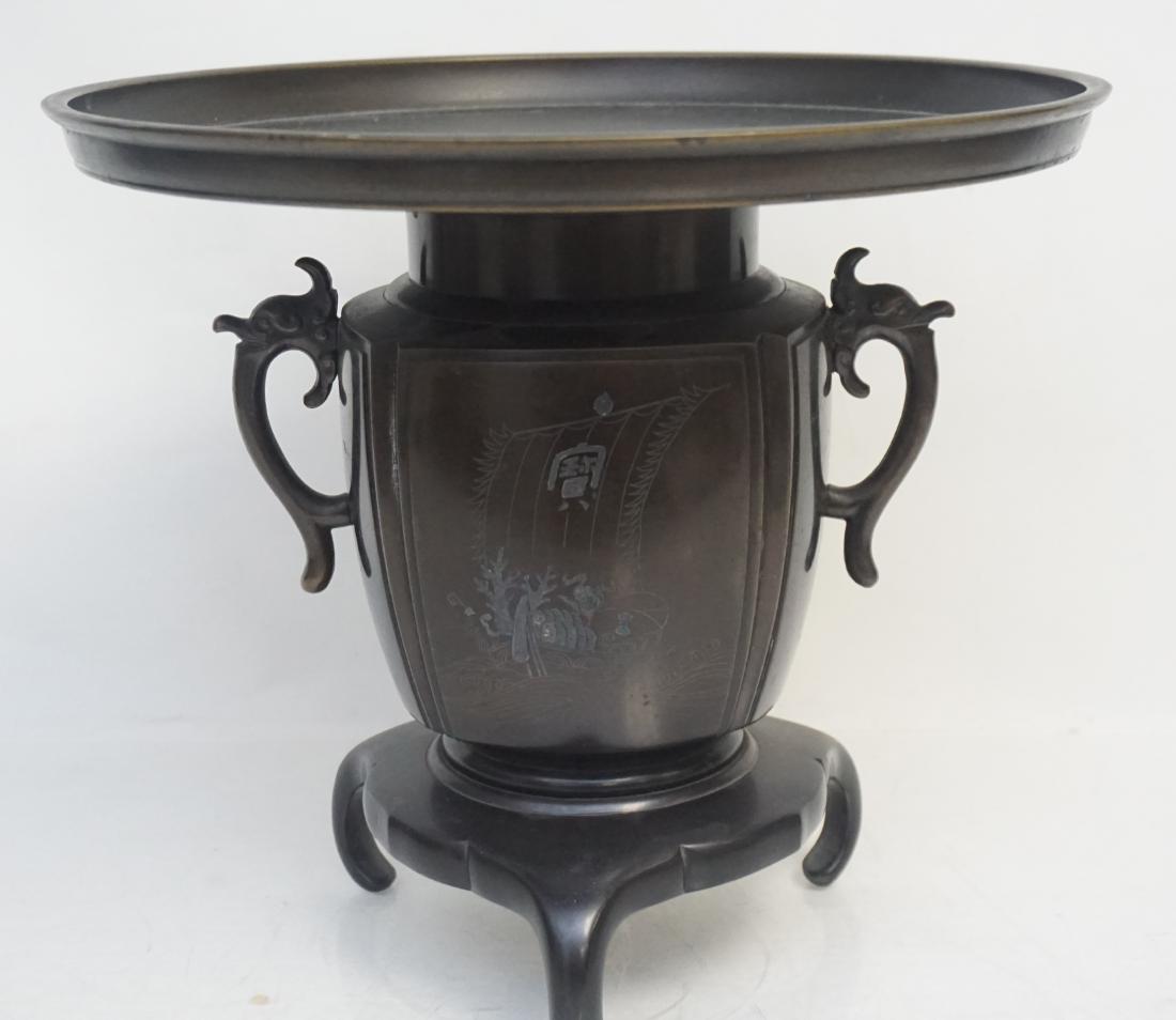 ANTIQUE BRONZE JAPANESE USUBATA: Exceptional Antique Bronze Meiji Period Traditional Usubata. Patinated, handled Urn Form on Tripod Base, wide bronze insert, etched panel. These were often used in tea ceremonies as centerpieces to di