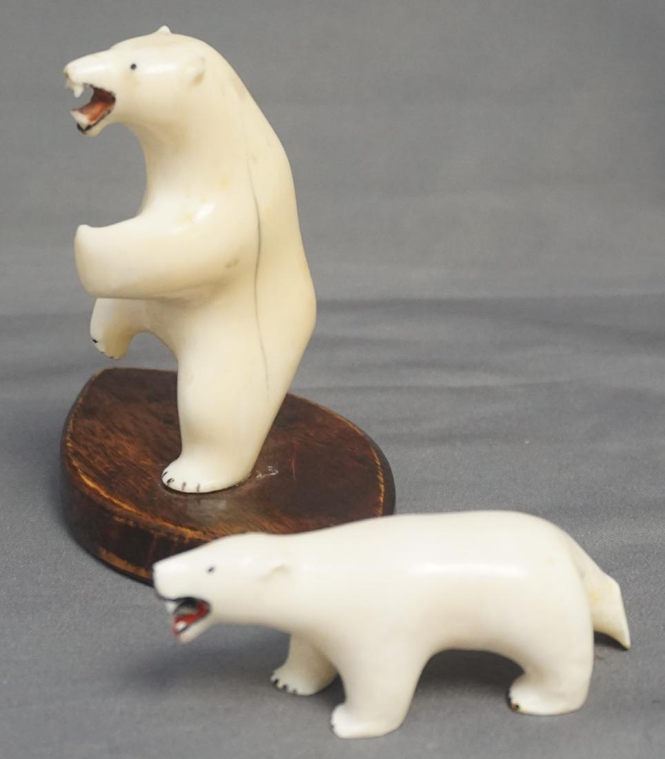 2 INUIT CARVED POLAR BEARS WALRUS FOSSIL: Two Inuit Hand Carved Polar Bears. One Standing on wood base 3 1/2" and the smaller with artist initials. 2 3/4" long. Weight 5.8 oz. PROVENANCE: A Private Charleston SC Estate. Alaskan native collect