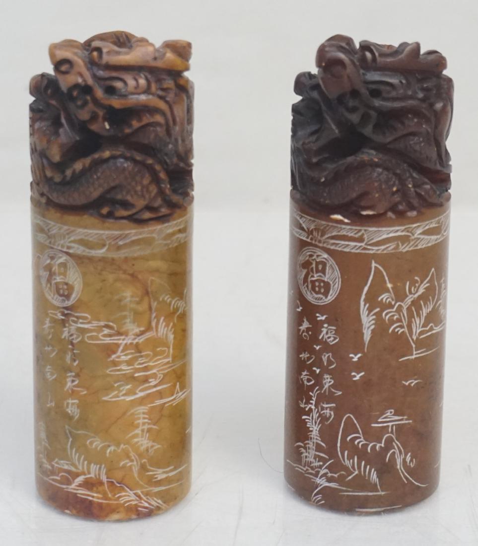 2 CHINESE CARVED SOAPSTONE DRAGON SEALS: Pair of Chinese Carved Soapstone Dragon Seals. Both topped with 2 dragons and the elusive pearl of wisdom. Etched sides and with hanzi. Each 4 3/4" Weight combined 1 pd 11 oz. PROVENANCE: A Private Ch