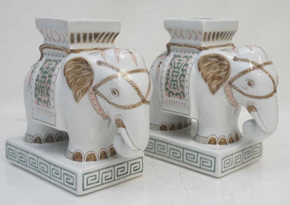 2 PORCELAIN ELEPHANT VASES: 2 Matching Porcelain Figural Garden Seat Elephant Vases. Hand painted, Thailand. They measure 7 1/2"x3 3/4"x3 3/4". Weight 3 pds. PROVENANCE: A Private Charleston SC Estate.