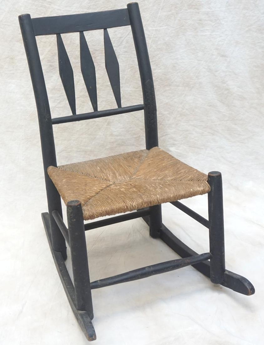 ANTIQUE AMERICAN CHILDS ROCKING CHAIR: 19th c. American Childs Rocking Chair. Rush Seat, arrow back.Measures 18 1.2"x25"x28". PROVENANCE: A Private Charleston SC Estate.*****Pickup only or Shipping on furniture offered through R & B Shippi