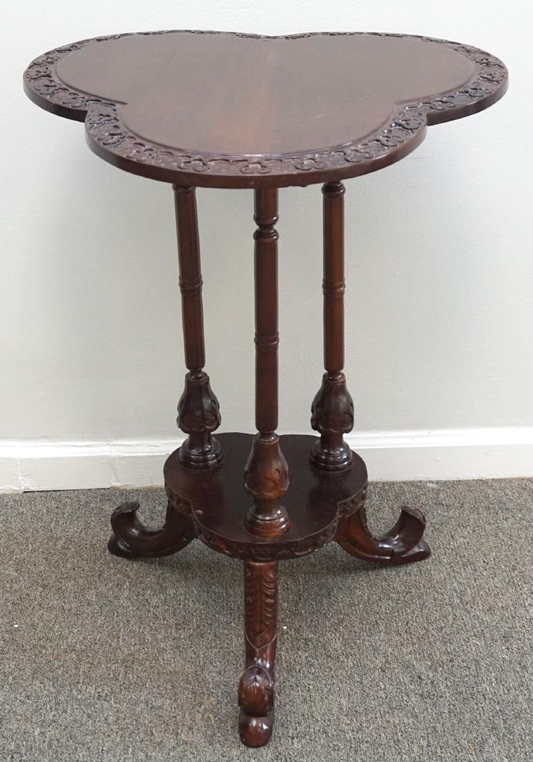 MAHOGANY CLOVER SIDE TABLE: Mahogany Irish style side table with a top in a clover shape, very nicely carved all around and resting on 3 turned and carved legs. Good condition. Measures 2 1/2"x21 1/2"x28". Weight 14 pds. PROVENA