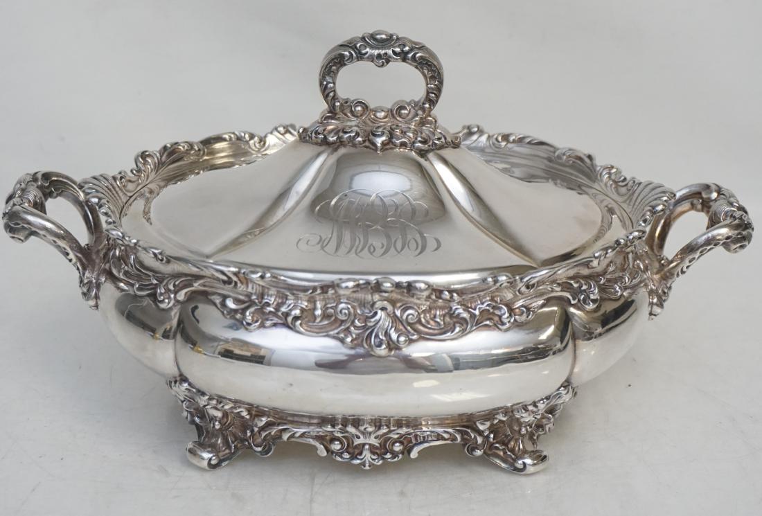 AMERICAN STERLING COVERED VEGETABLE C. 1890: Dominick & Haff American Sterling Silver Covered Vegetable Tureen c. 1890-1900. Of shaped oval form, rococo scroll rim, with two stylized scroll handles, the cover centering a ring finial, on foliate 