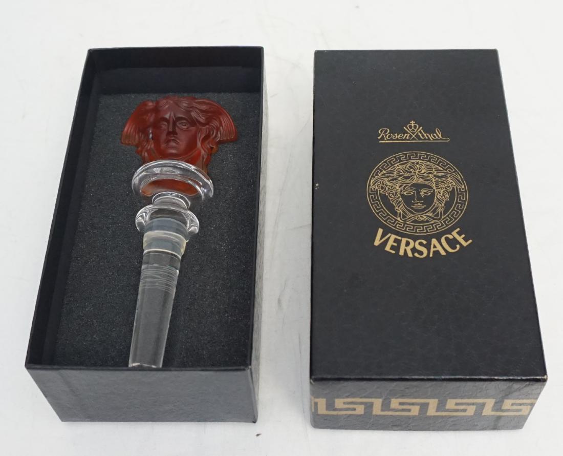 VERSACE AMBER WINE STOPPER: Rosenthal Versace Amber Medusa Glass Wine Bottle Stopper. In the original box. Box 6 1/4"x3 1/2"x2". Weight 6.9 oz. PROVENANCE: A Private Charleston SC Estate.