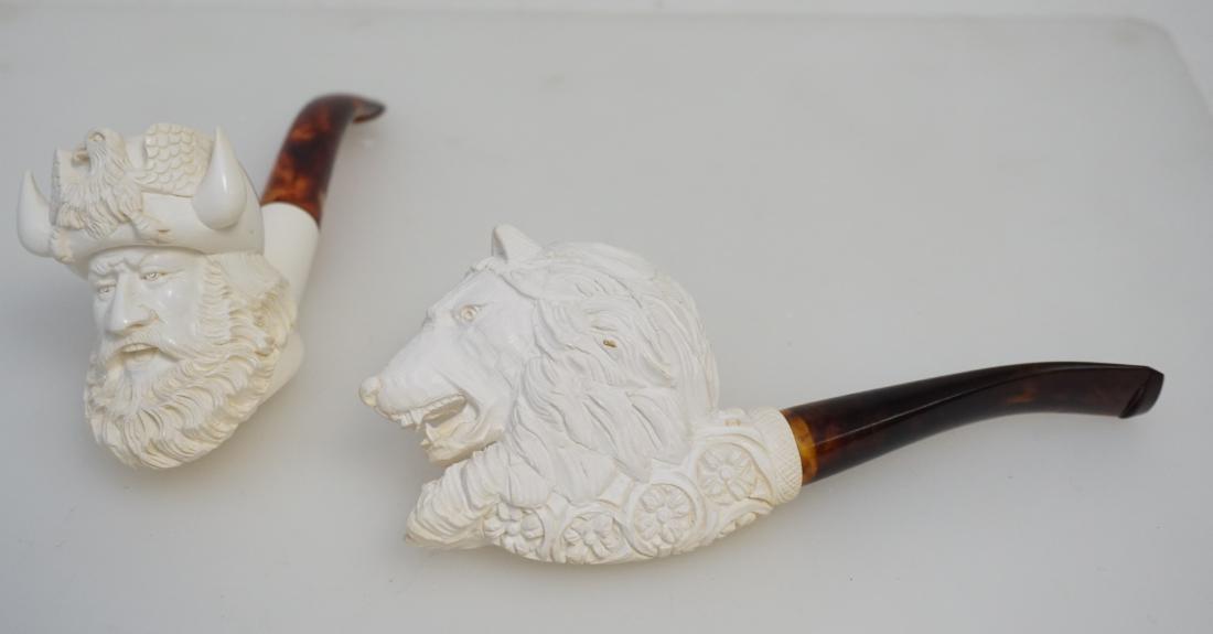2 MEERSCHAUM CARVED PIPES: Both pipes are in excellent unused condition. 1- Altina Viking 6 1/4". 2- Wolf Head with Tusks 6 1/2. These carvings, like all Meerschaums is from a single block and it is treated with a beeswax dip t
