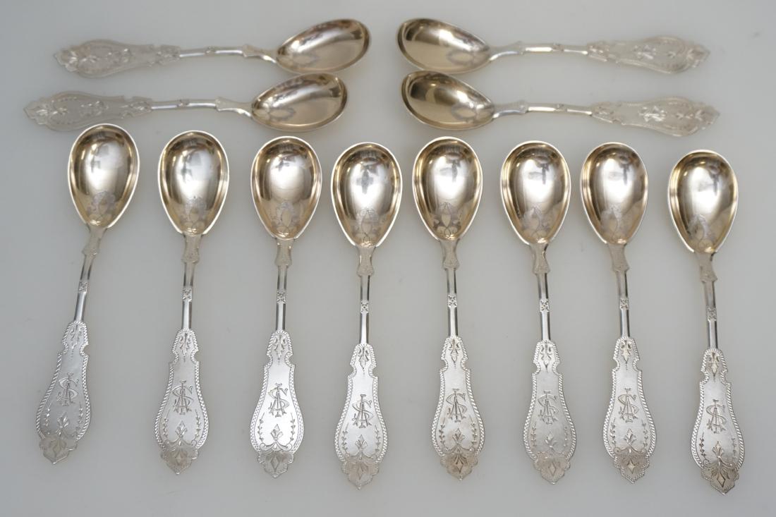 12 AMERICAN COIN ICE CREAM SPOONS: Twelve Duhme & Co Antique Coin Silver Ice Cream or Berry Spoons, Cincinnati, OH, c. 1860's. Complete set of 12. Monogrammed. The elongated, oval bowls are covered in gold wash with stylized hand engra