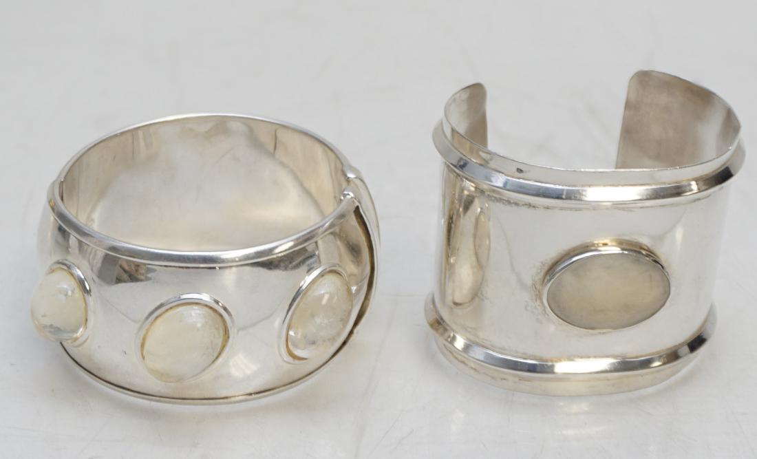 2 PC DESIGNER CUFF BRACELETS 1 STERLING: 1- Sterling Silver 2" Modernist Cuff Bracelet by designer Julia Booth,60 grams Adjustable opening 2 1/4. 2- Silver tone Hinged Cuff Bracelet set with Lucite Cabochons 1 1/2" opening 2 1/2". PROVENANCE