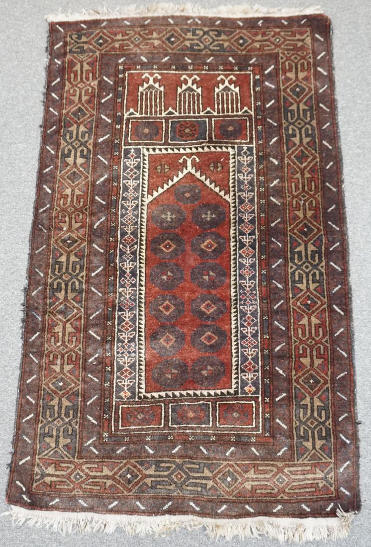 ANTIQUE BOKHARA PRAYER RUG: Antique Hand Knotted Bokhara Prayer Rug. Having a red ground with brown and cream borders. Measures 56.50" x 35" (fringe 1.5" each side). Approx 12 pds. PROVENANCE: A Private Charleston SC Estate.