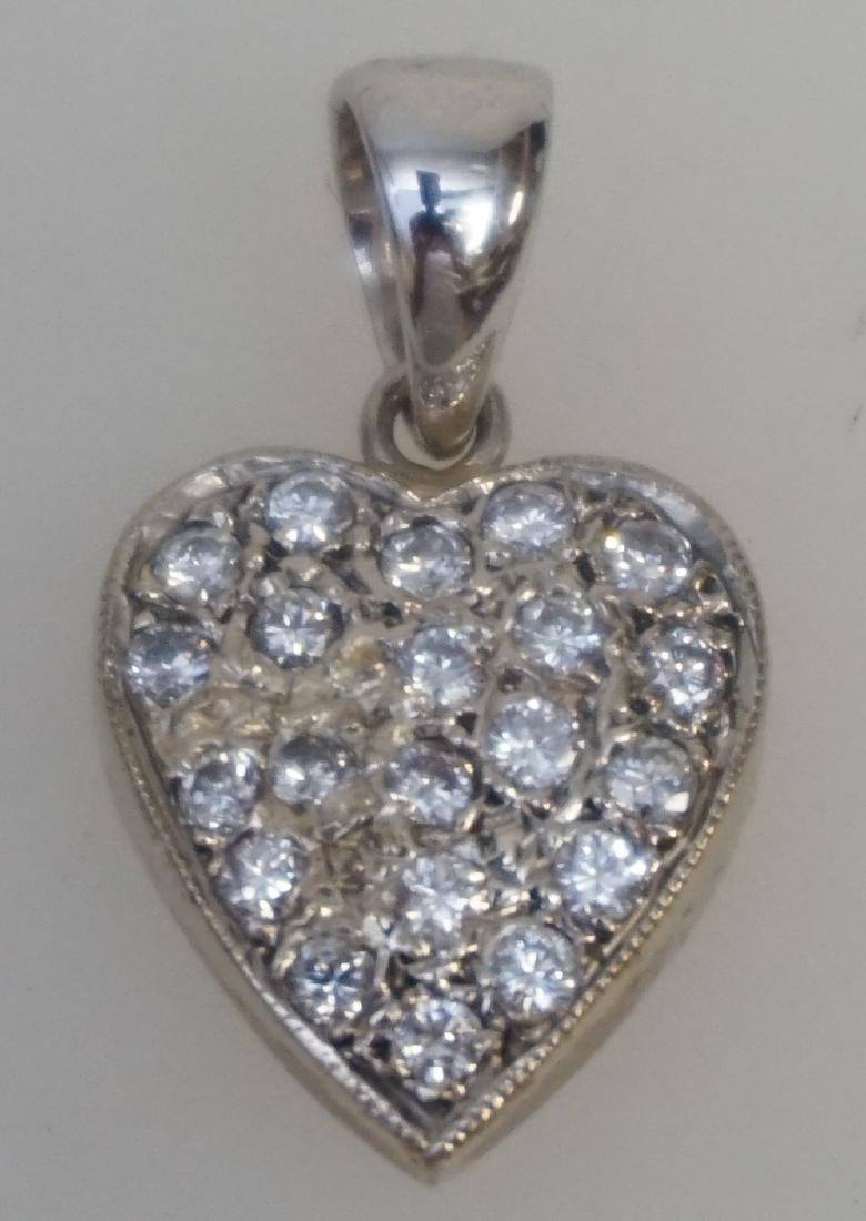 DIAMOND HEART PENDANT (0.50 CTS/TW): One 14kt & 18kt white gold diamond heart pendant. The pendant features a total of twenty-one (21), pave set, round brilliant cut diamonds set on a 14kt white gold heart shape plate which measures appr