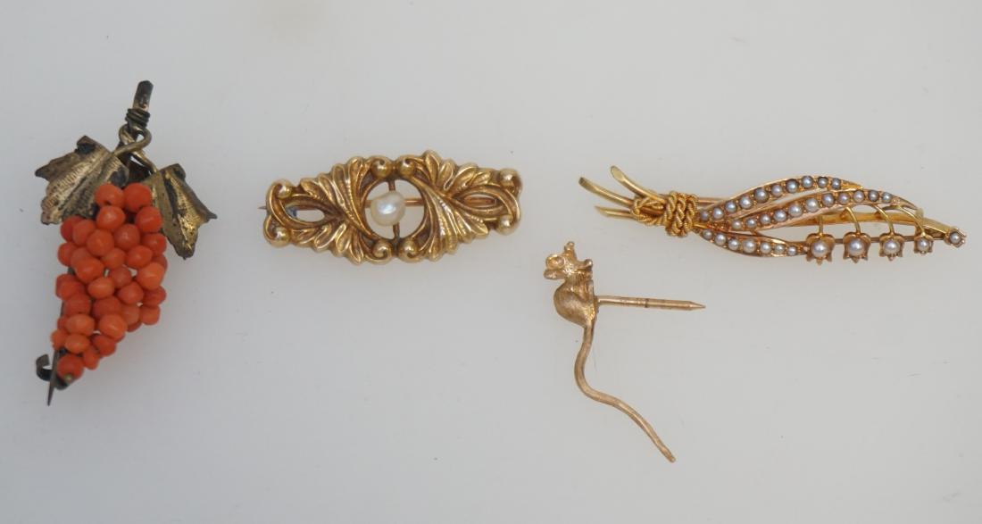 4 ANTIQUE 14k + CORAL BROOCHES: 4 Victorian / Edwardian Brooches. 3 are 14k and include mouse 1", Lily with seed pearls 1 1/2" and Pearl Center Scroll 1 1/4". Weight on gold is 7.7 grams. In addition there is a classic Victorian Cor