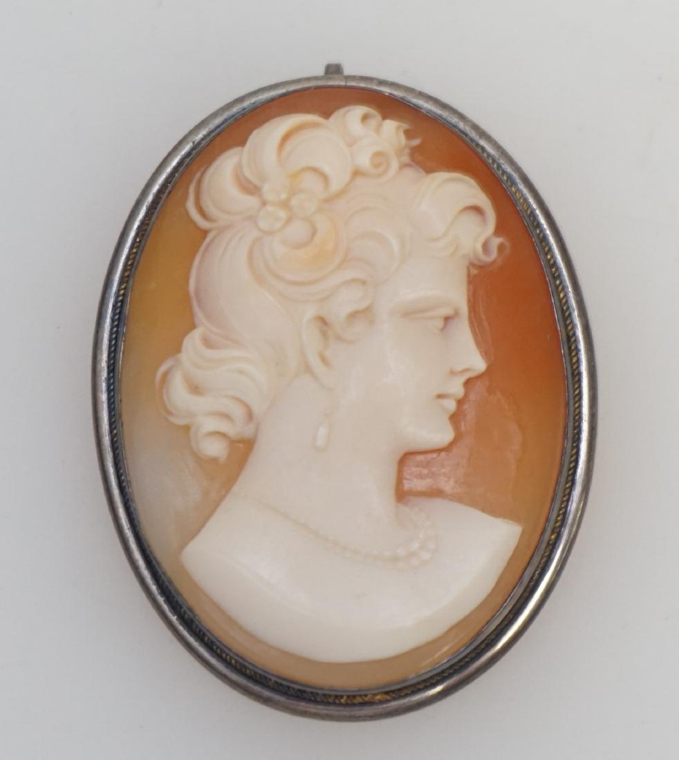 EDWARDIAN CARVED CAMEO IN SILVER: Edwardian carved natural shell Cameo Brooch / Pendant set in a 800 silver Frame with gold rope border around bezel 2 3/4". PROVENANCE: A Private Charleston SC Estate.