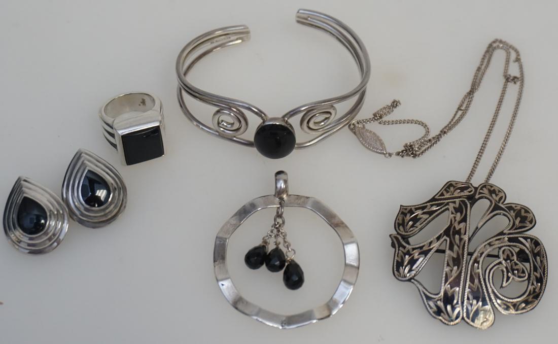 5 PC STERLING JEWELRY JAMES AVERY +: 1- Sterling Silver Onyx Ring by James Avery sz. 5. 2- Scroll Sterling Cuff Bracelet Onyx. 3- Sterling Hoop Pendant with 3 faceted black crystals. 4- Japanned Sterling Pendant / Brooch 1 3/4". 5- Silve