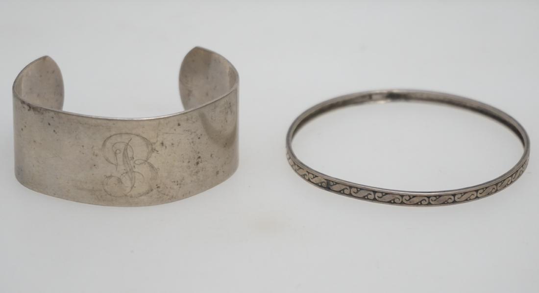 2 ESTATE STERLING BRACELETS: 2 Vintage Estate Sterling Silver Bracelets. A etched bangle, opening 2 1/2" and a Lunt Cuff Bracelet, monogrammed 2 1/2". Weight on all 45 grams. PROVENANCE: A Private Charleston SC Estate.