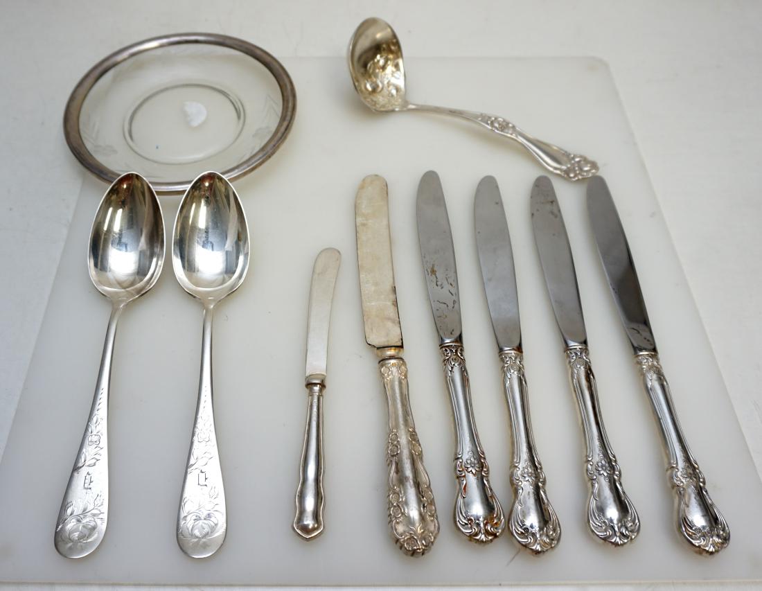 11 pc ANTIQUE & VINTAGE STERLING + SILVERPLATE: Assorted. Etched Glass Sterling Footed Bud Vase 9 /2". Sterling Rim Glass Plate 6". Holmes & Edwards Ladle, 5 Various Dinner Knives, English Sterling Handle Butter Spreader, 2 Goldmans Special Serving