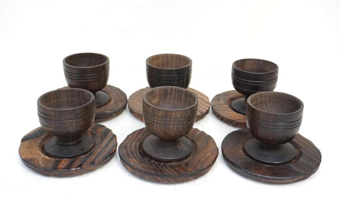 6 HAND TURNED WOOD EGG CUPS + SAUCERS: Six Hand Turned Elm Wood Egg Cups with Saucers. Cups 2" Saucers 3 1/2". Weight 1 pd 2 oz. PROVENANCE: A Charleston SC/Tokyo Private Collection