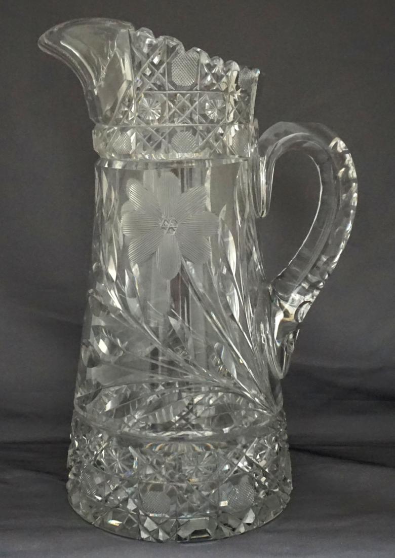 AMERICAN BRILLIANT CUT GLASS TANKARD PITCHER: American Brilliant Period Cut Glass Tankard Pitcher. Cane cutting and cut corn flower with an applied cut handle and rayed base. Unsigned. Measures 7"x5 1/4"x11". Weight 5 pds 3 oz. PROVENANCE: A Char