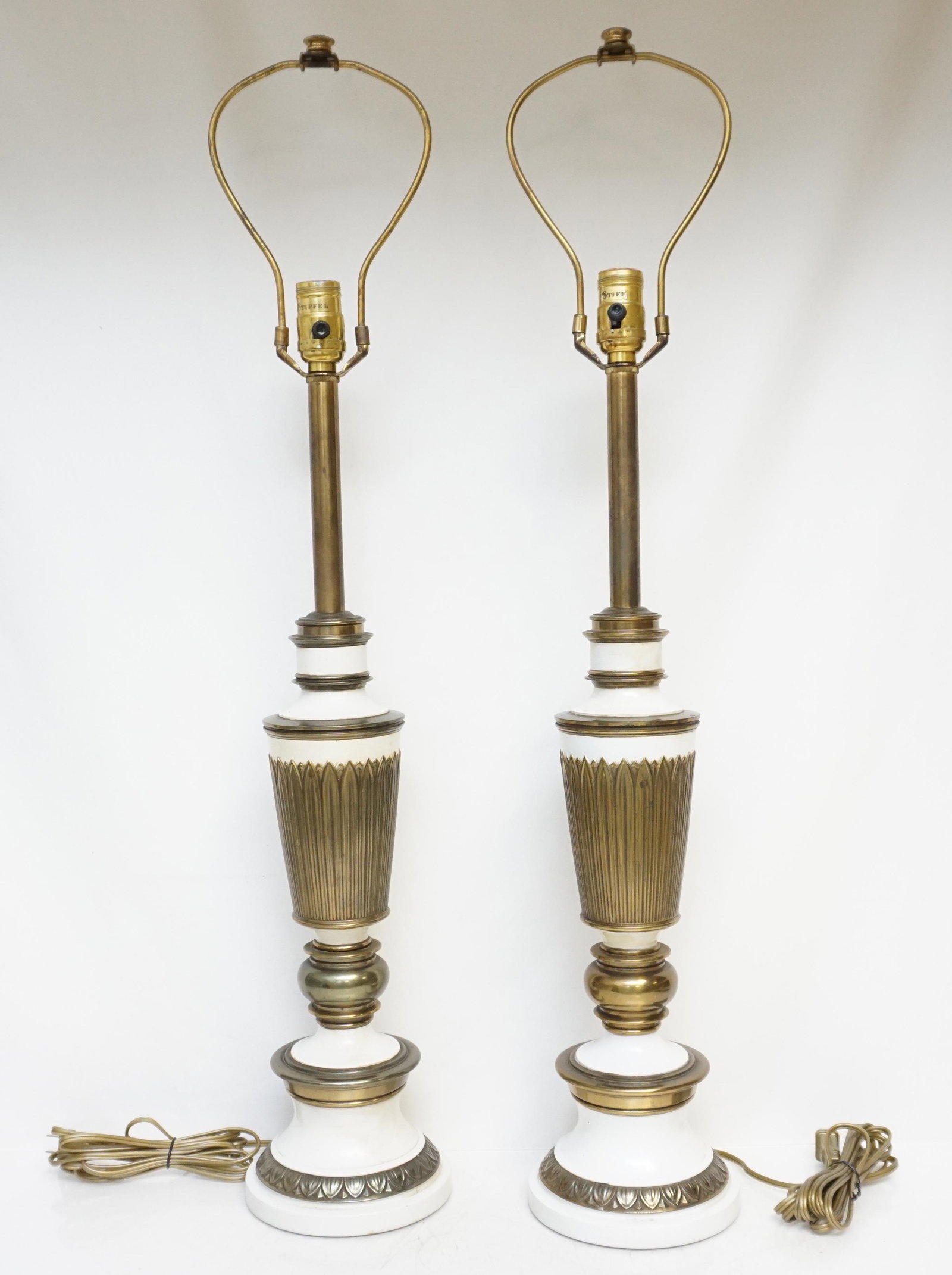 PAIR OF MID CENTURY STIFFEL LAMPS: Matched pair of Stiffel Mid Century Table Lamps. White enameled brass. Dimensions: H 27" (not including harp) x Dia: 5" (base). 34" to top of harps. Weight combined 12 pds 10 oz. PROVENANCE: A Private