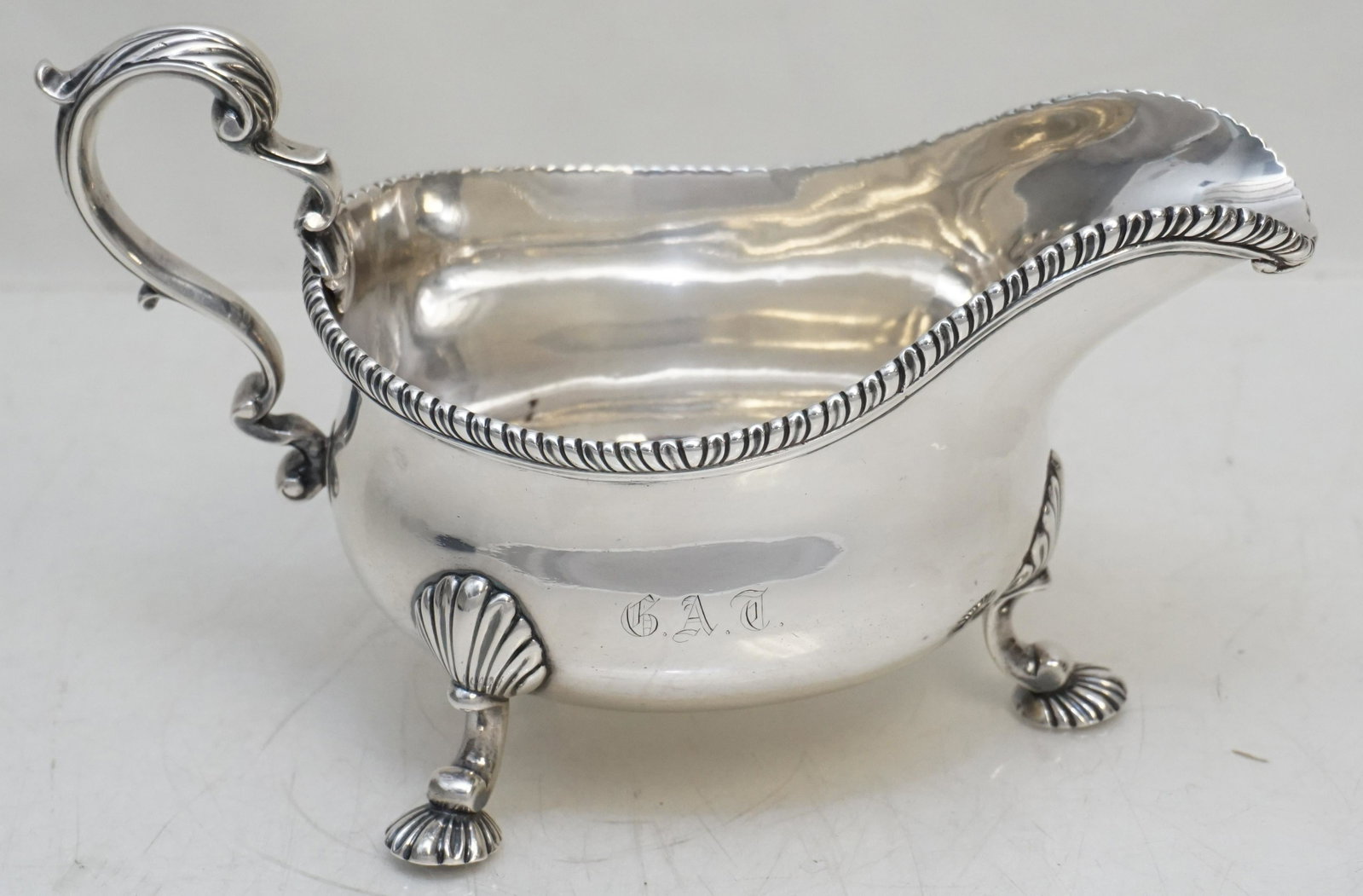 LARGE STERLING GEORGE III GRAVY / SAUCE: Substantial English Sterling Footed Georgian c. 1773 Gravy / Sauce Boat. Monogrammed G.A.T. for George Alfred Trenholm was a South Carolina businessman, financier, politician, and planter who owned se
