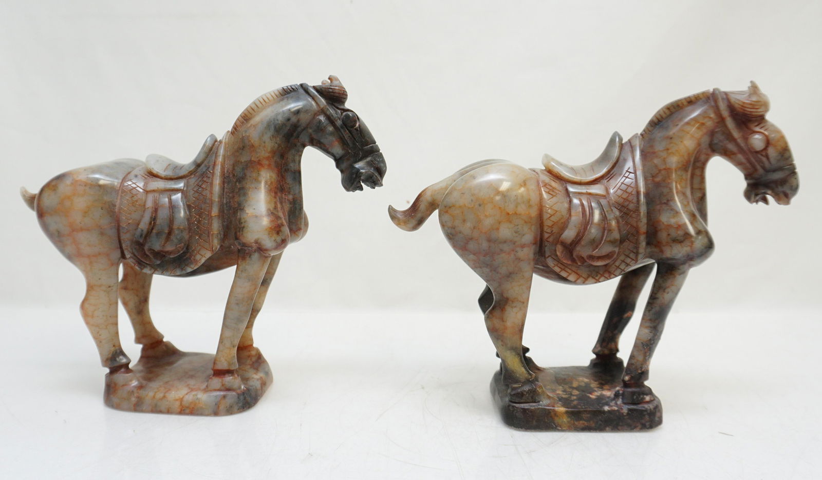 PAIR NEPHRITE JADE TANG HORSES: Pair of hand carved Chinese Nephrite Jade Tang Horses. 19th/20th century, Qing Dynasty. The jade mottled grays and heavily veined in blood red. Each 7 1/2"x3"x7". Weight 5 pds 11 oz. PROVENANCE: A Pri