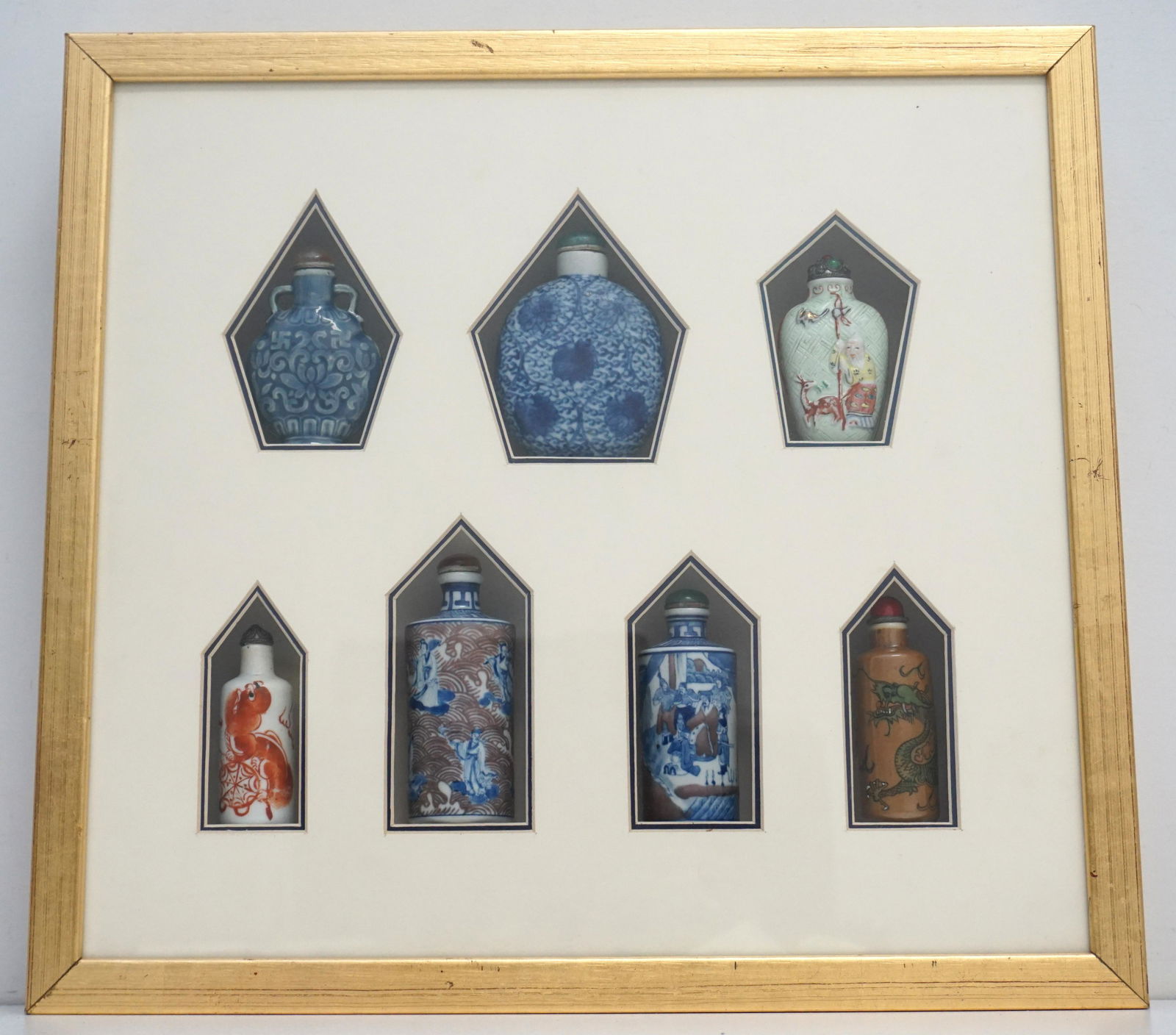 7 CHINESE PORCELAIN SNUFF BOTTLES: Seven Antique / Vintage Chinese Porcelain Snuff Bottles. Purchased and framed in a Gilt wood Shadowbox Frame at Zhang's Textiles, Beijing. Good condition, measures 16"x15"x2 1/2". Weight 5 pds 9 oz. P