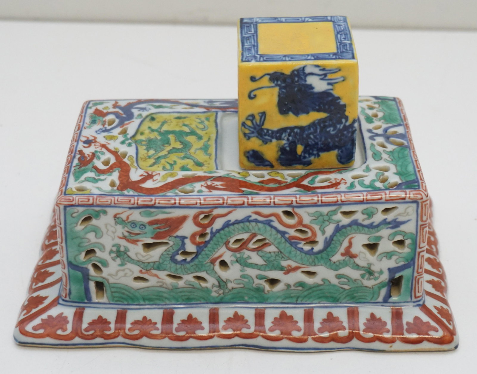 MING WUCAI PORCELAIN DRAGON SEAL: Rare Chinese Ming Dynasty Wucai porcelain dragon seal. Seal of Cube Form, yellow with blue dragon chasing divine flaming pearl, the underside carved with six seal script, with extensive trace of red p