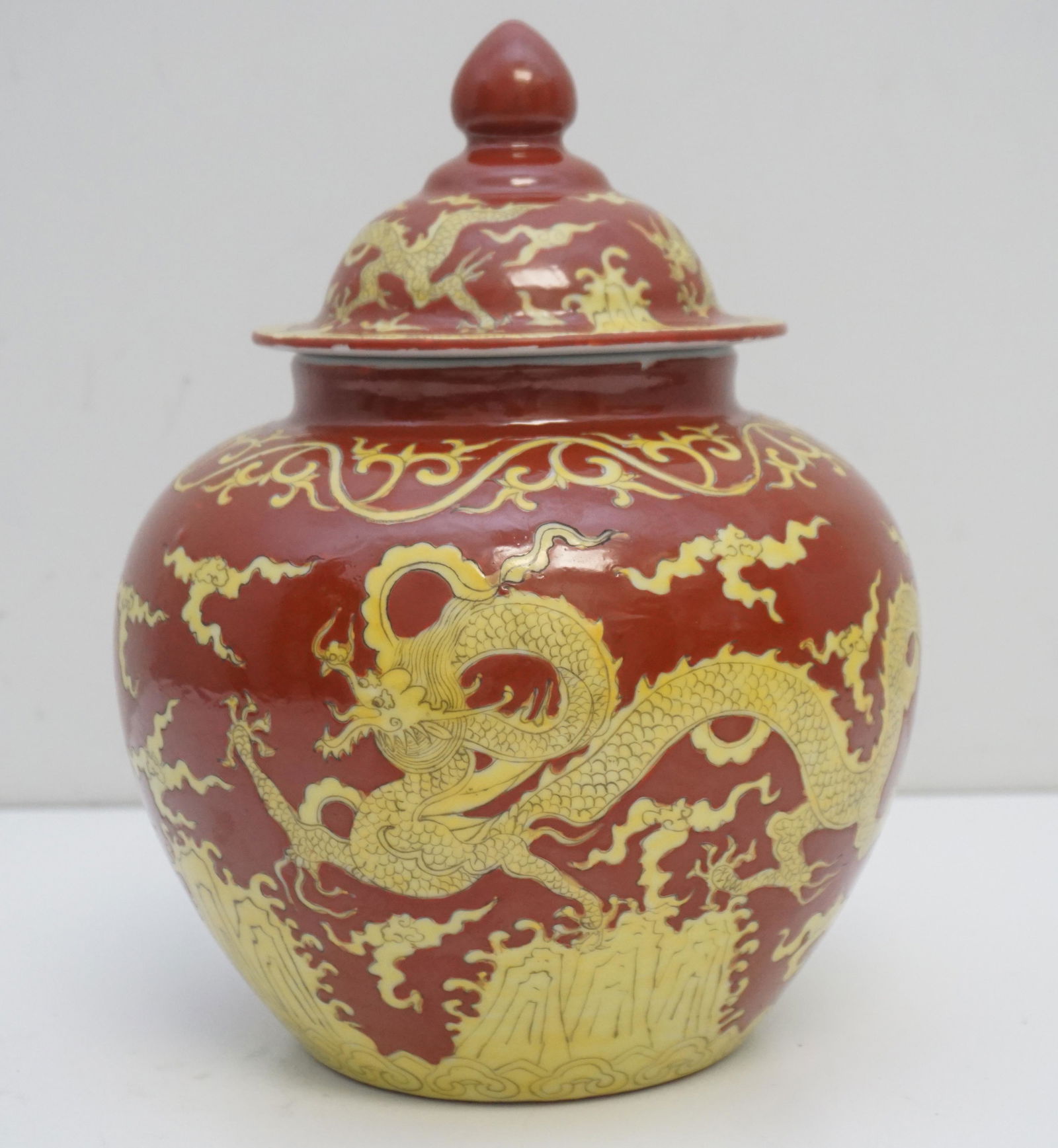 CHINESE 19th c STYLE GINGER JAR: 19th Century Style Chinese Covered Ginger Jar. With Ming mark. Red background. Yellow motif of dragons. Measures 9"x9"x10 1/2". Weight 6 pounds. With "Jian Ding" (Certified Export approval seal mark)