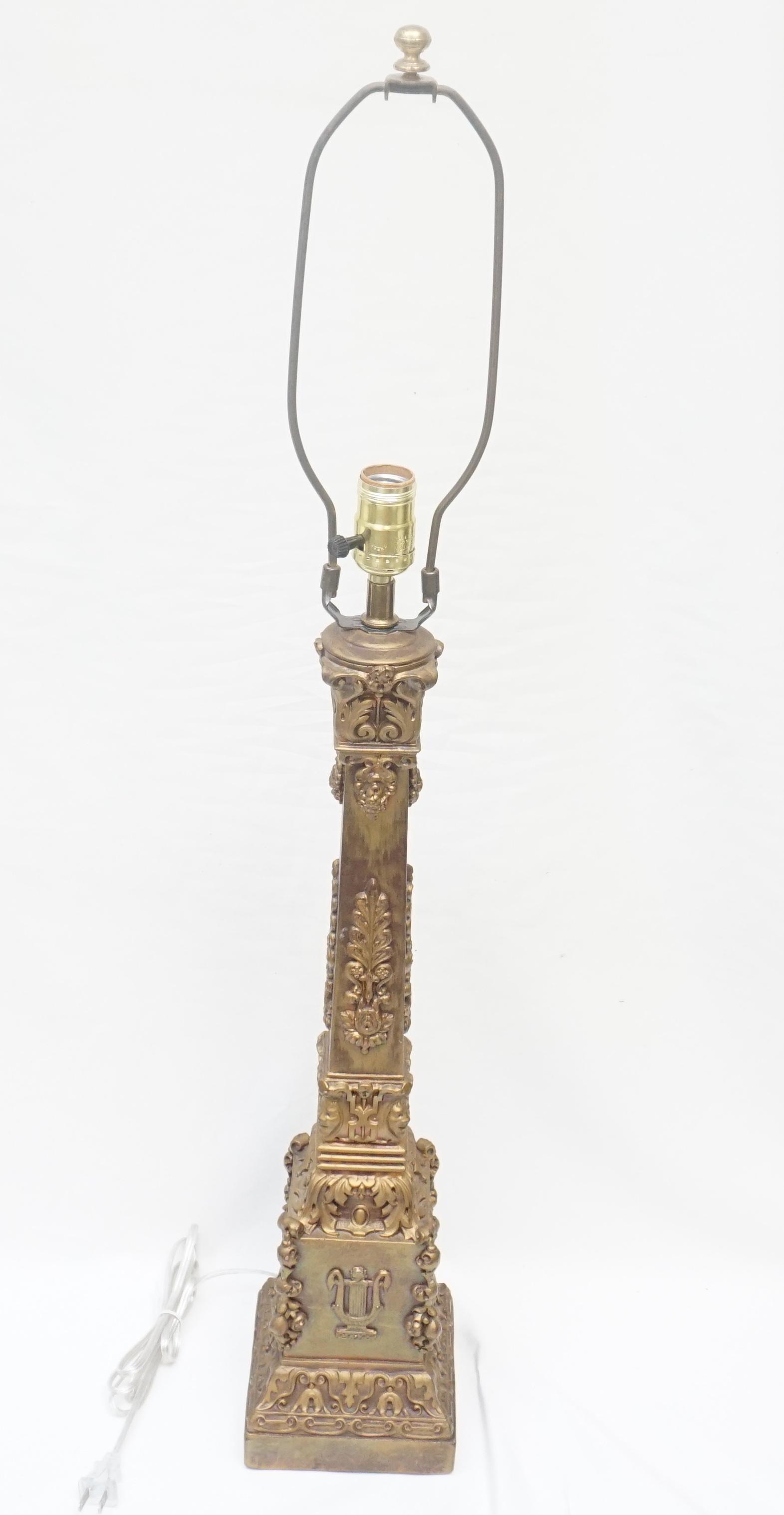 TALL ORNATE CAST PLASTER TABLE LAMP: Early 20th c. Tall Gilt Cast Plaster Table Lamp. Classical style with Lyre, Faces and Foliage. Rewired, Measures 5 3/4"x5 3/4"x27" without the harp. Weight 8 pds 9 oz.PROVENANCE: A Private Charleston 