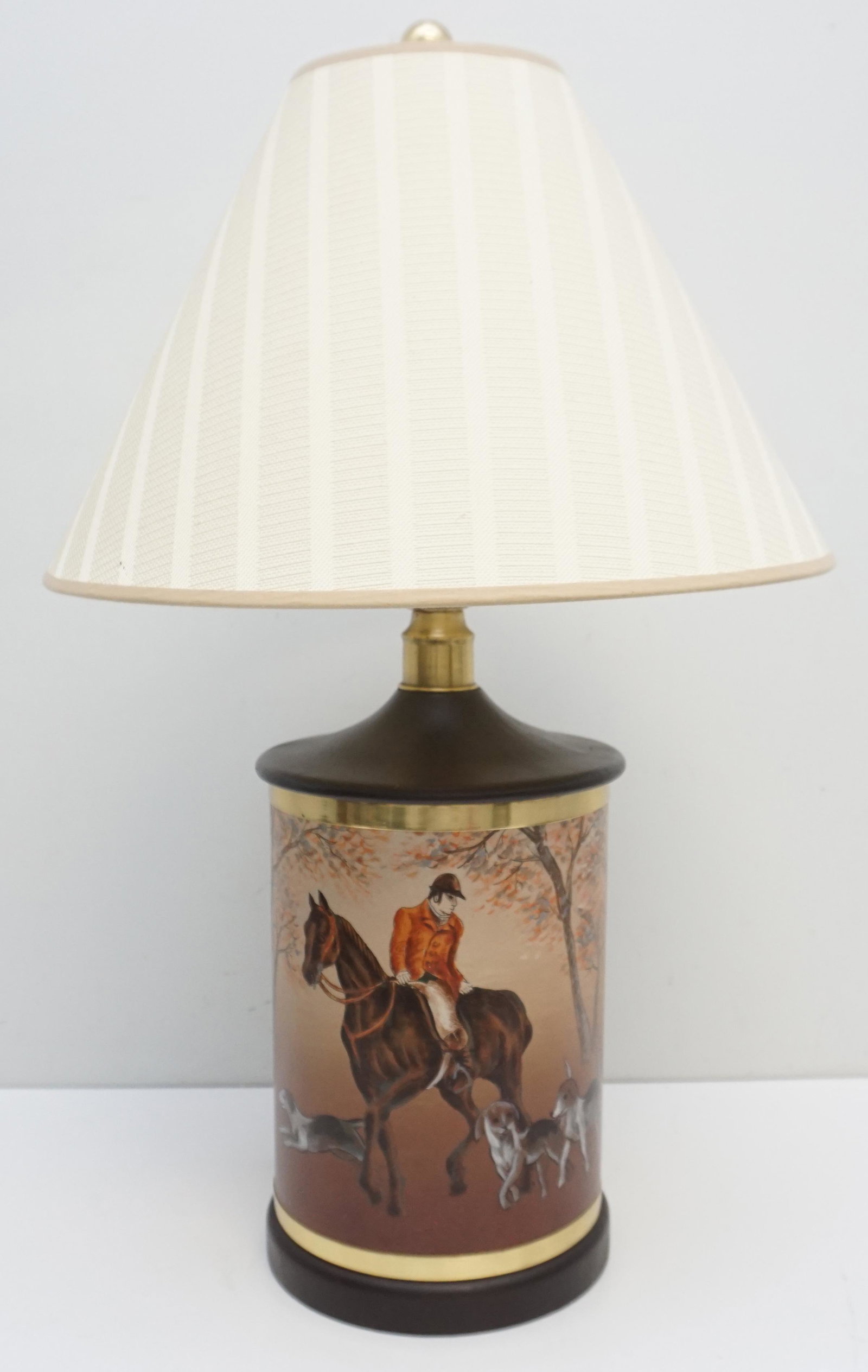 LEATHER PAINTED HUNT SCENE LAMP: Vintage Hand Painted on Leather Hunt Scene Lamp. Lamp featuring hounds and rider with fall foliage. Lamp without harp 9"x9"x18". Shade 18"x18"x12 1/2". Weight 9 pds PROVENANCE: A Private Charleston SC