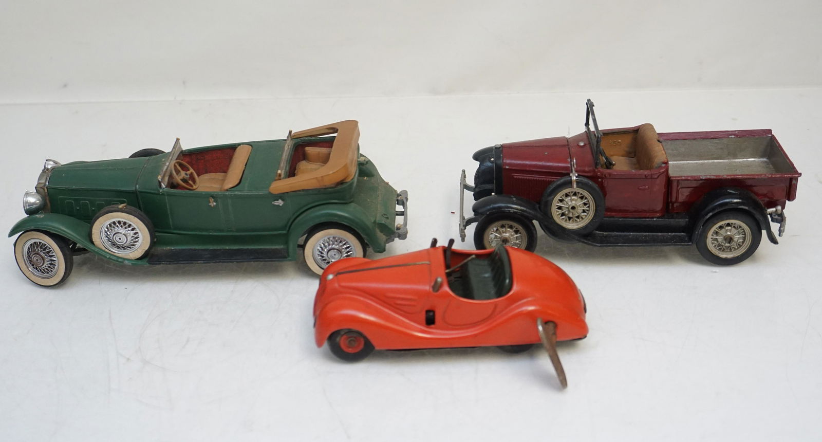 3 VINTAGE HUBLEY + SCHUCO CARS: 1- Schuco Examico 4001 Wind Up Tin Car. Windshield and steering wheel missing. Key included, does work. 2 - Hubley 859K Packard Car, For Parts or Restoration, missing both windshields. Convertible top