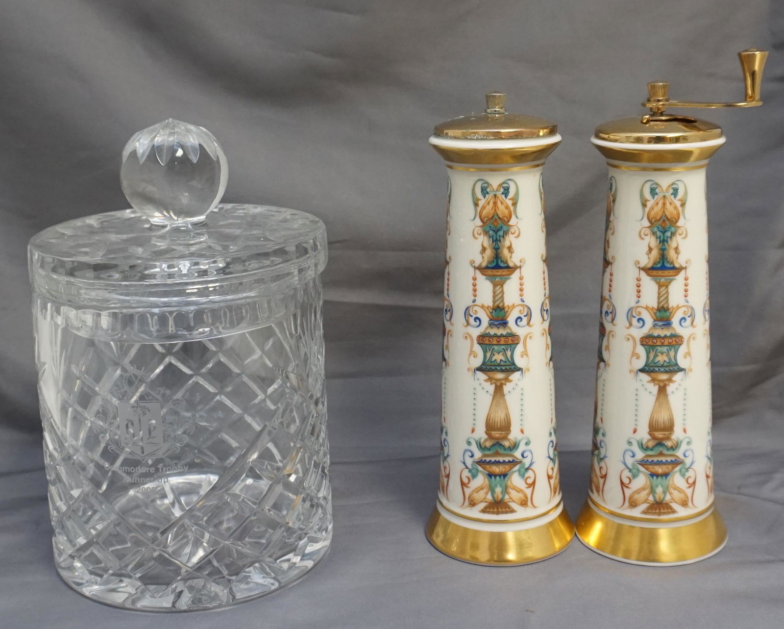 CRYSTAL BISCUIT BARREL + LENOX SALT & PEPPER: 1- Badash Crystal Biscuit Barrel - Commodore Trophy Runner Up 2005. 5"x5"x7 3/4". Lenox Porcelain Tall Salt and Pepper Grinder both 7 1/2". Weight on all 5 pds. PROVENANCE: A Private Charleston SC Est