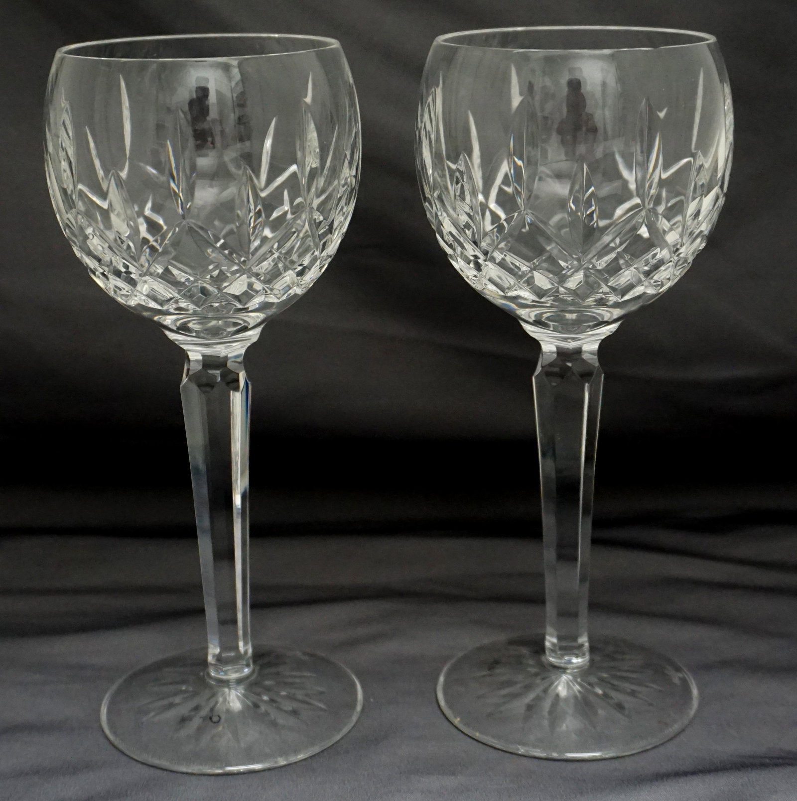 PAIR WATERFORD LISMORE HOCK GLASSES: Two Waterford Lismore Wine Hocks. Both with the signature diamond and wedge cuts of the classic Lismore pattern and acid etched signature. Each 2 3/4"x7 1/2". Weight 1 pd 6 oz. PROVENANCE: A Charlesto