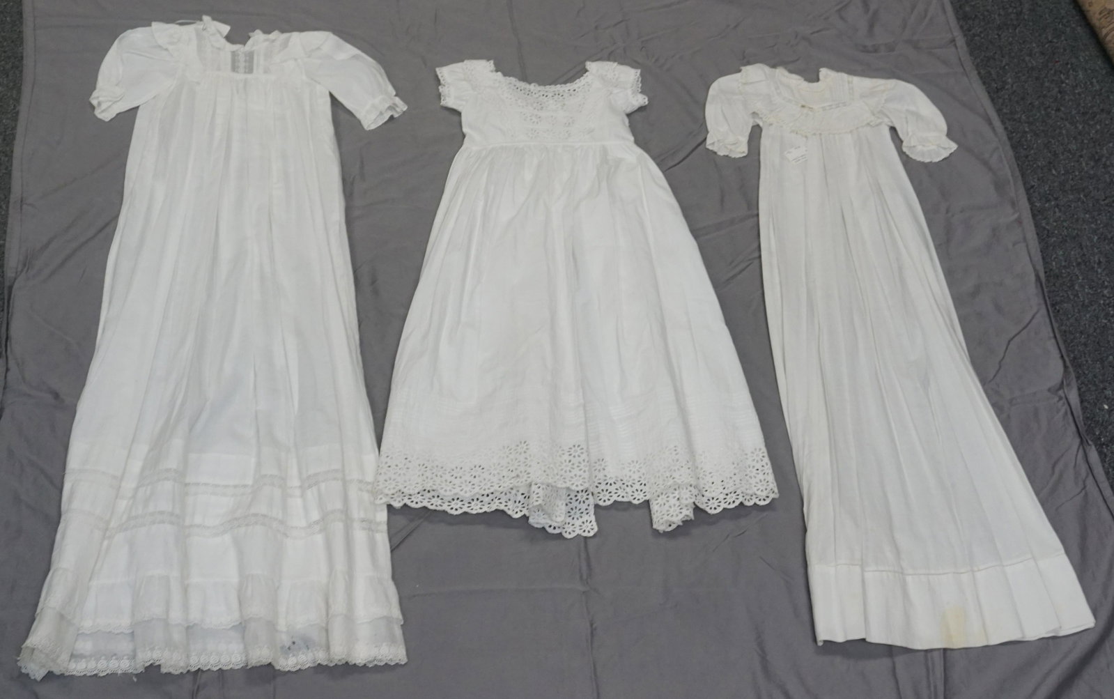 3 VICTORIAN CHRISTENING GOWNS: Three Victorian / Edwardian Christening Gowns c. 1900-1912. One with eyelet lace has underslip as well. Perfect lot for collectors. Longest is 41". Weight to ship 1 pd.PROVENANCE: A Charleston SC Priv