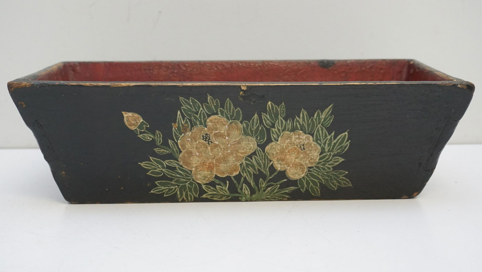 CHINESE WOOD LACQUERED JARDINIERE: A Chinese Lacquered Elm Wood Jardiniere,19th century. Lotus flowers. Red interior. Measures 7"x14 1/2"x 4 1/2". Weight 1 pd 9 oz.