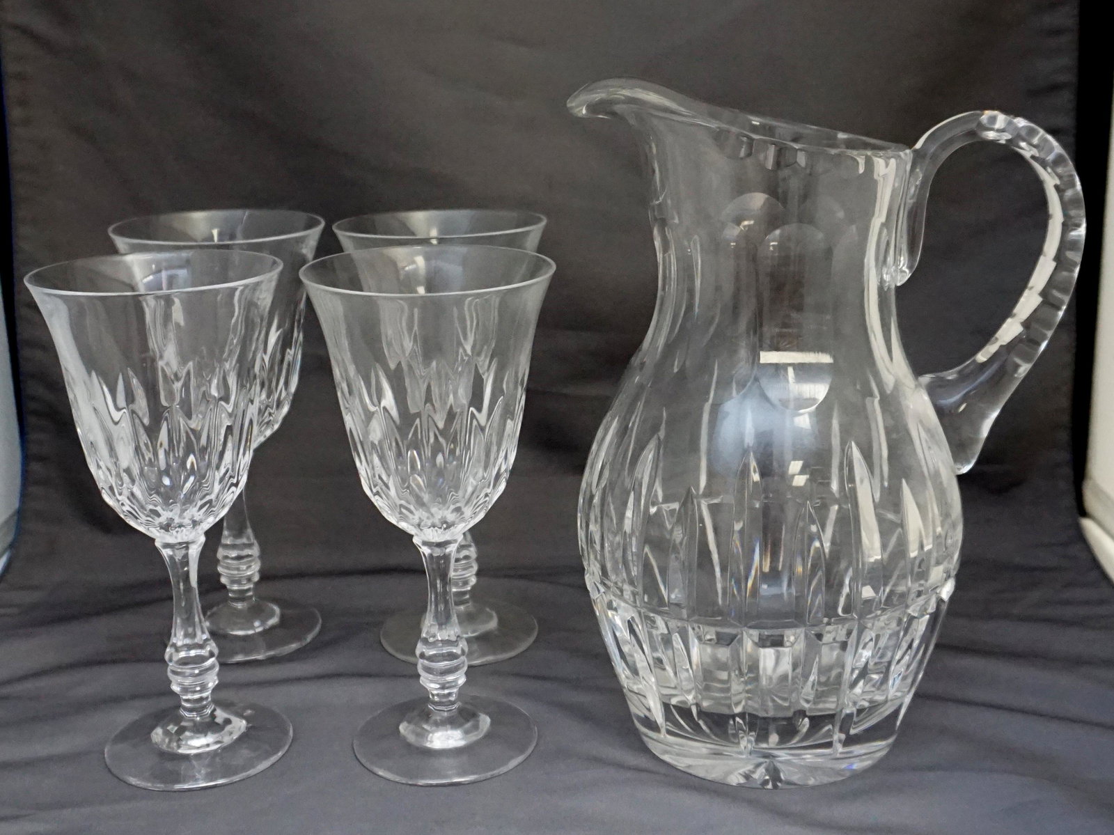 5 pc CUT CRYSTAL PITCHER + GLASSES: Five Piece Vintage Crystal Pitcher and 4 Wine Glasses. Pitcher 8 1/2" tall Glasses 6 1/2". Weight on all 5 pds 11 oz. PROVENANCE: A Private Charleston SC Estate.