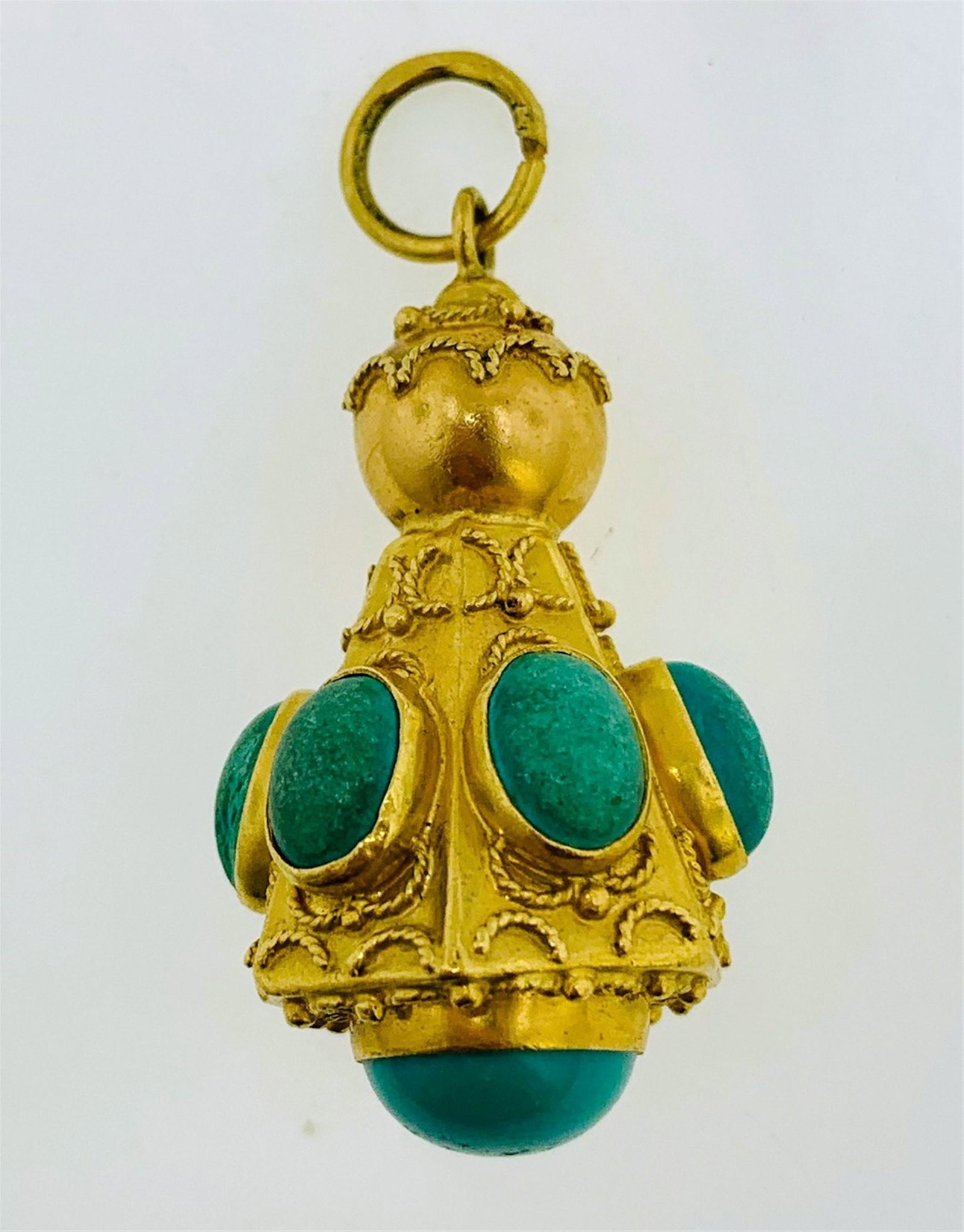 18KT GOLD ELABORATE BLUISH-GREEN STONE PENDANT (11.70: One 18kt gold elaborate urn shaped blueish green stone pendant. The pendant has a hexagonal urn shape set with six (6), bezel set, oval cabochon bluish-green stones on each of the walls which measure 