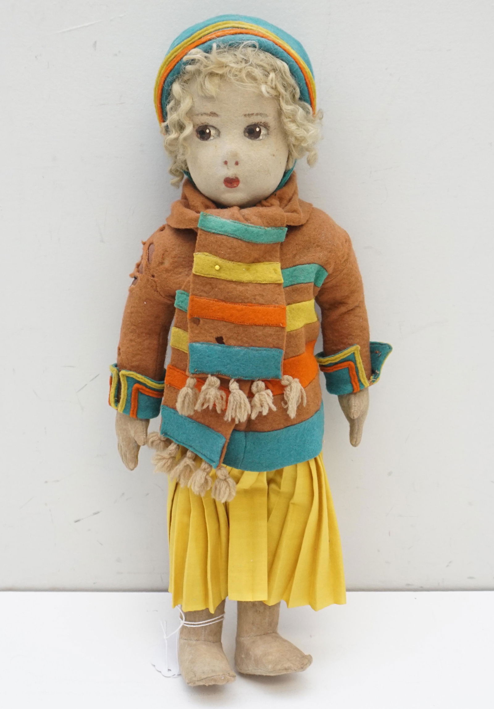 VINTAGE LENCI DOLL ITALY: Vintage Italian Pressed Felt Lenci Doll. Hand painted face, blond curls. All original clothing. Pleated yellow skirt, jacket, scarf and hat. Measures 16". Weight 1 pd. PROVENANCE: A Private Charleston