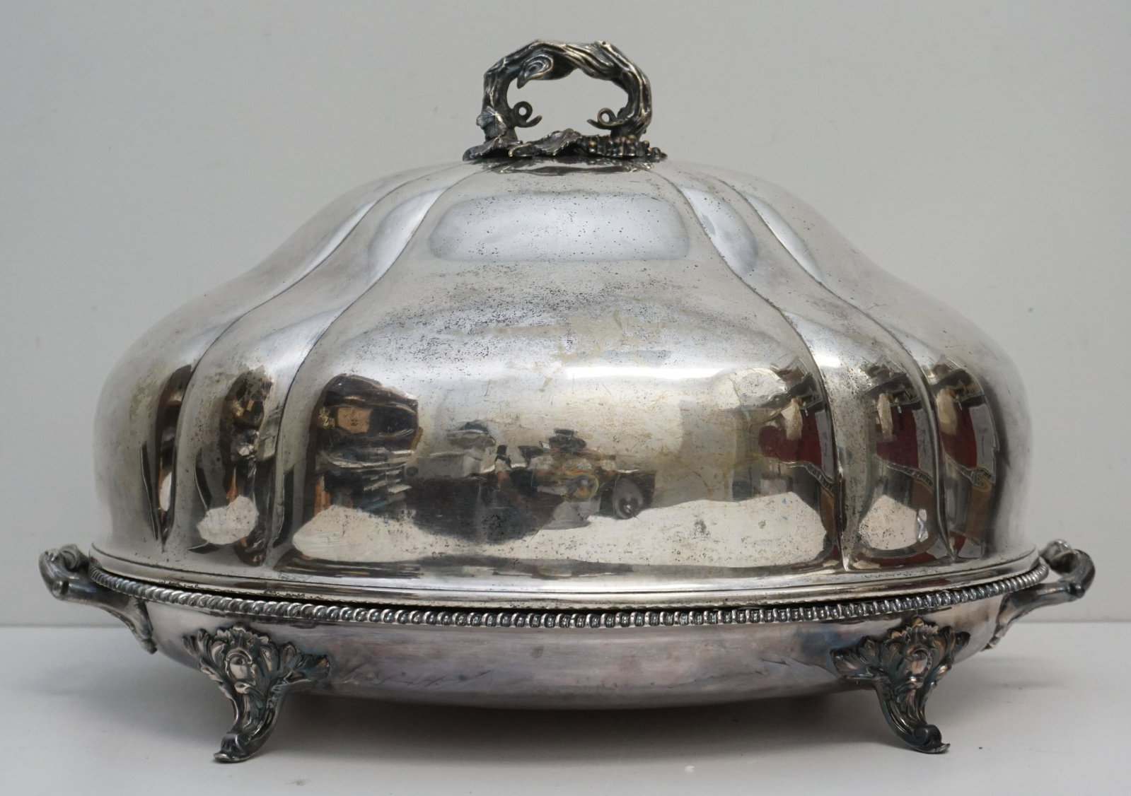 VICTORIAN SILVER PLATED MEAT DOME & WARMING TRAY: Extra Large Victorian Meat Dome and Warming Meat Tray. Large Meat dome with grapes and vine handle. Warming tray with well and tree, with regimental crest raised on four scrolled feet. Tray 24 1/2"x17