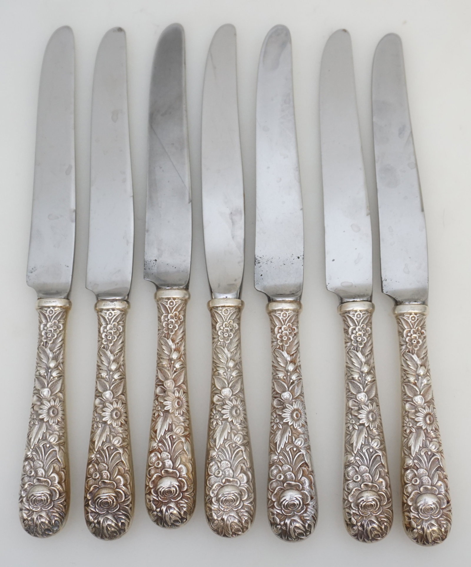 7 STERLING REPOUSSE S. KIRK AND SON KNIVES: 7 Sterling Silver Knives in the Repousse pattern by S. Kirk and Son (now, Kirk-Stieff), Baltimore, Maryland. No monograms. Stainless Blades. Repousse was introduced into America by Samuel Kirk in 1828