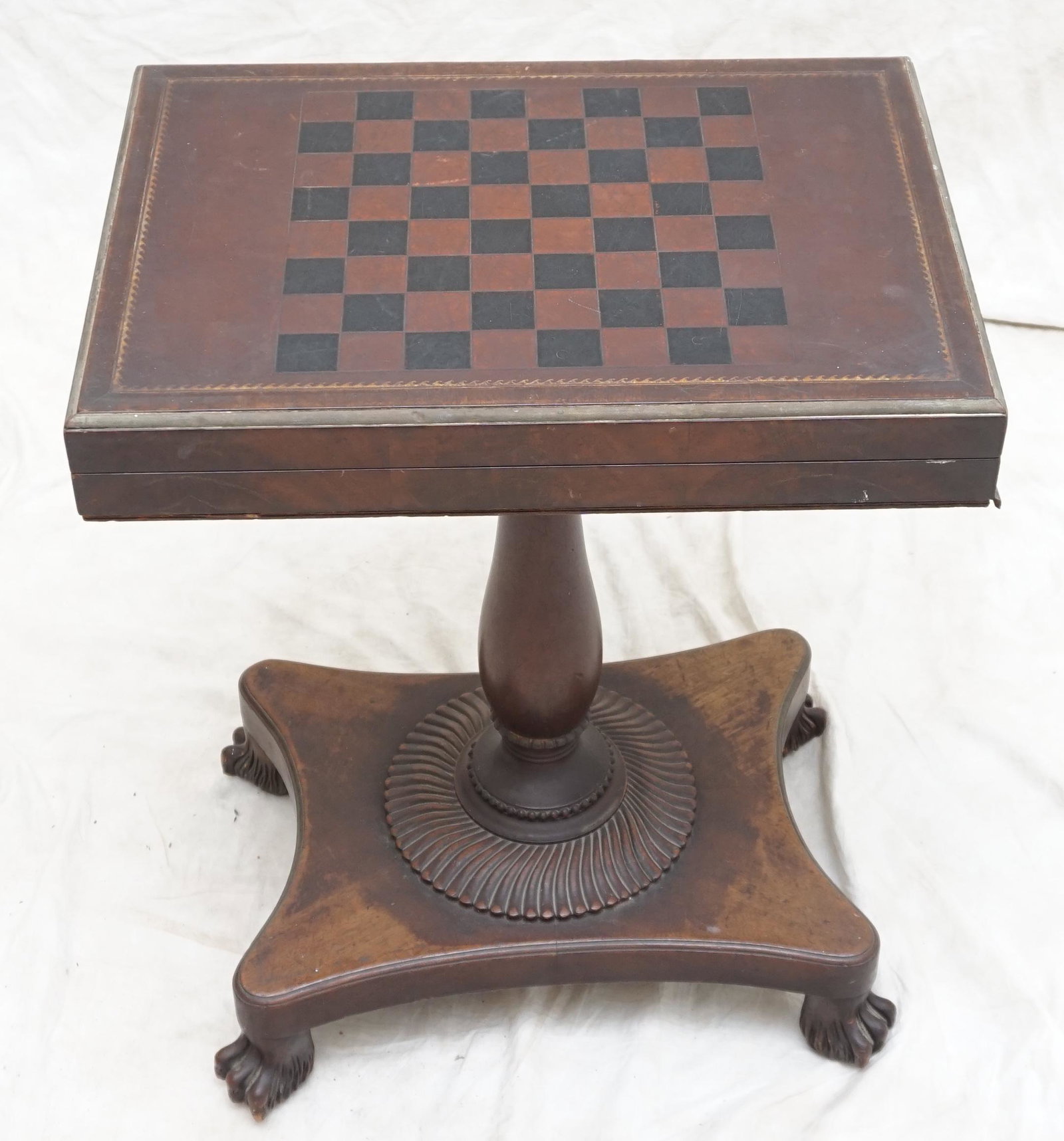 MAHOGANY PAW FOOT GAMES TABLE: 19th c. Mahogany Pedestal support game table with carved paw feet and tooled leather top. Measures 21"x15"x27" closed. Top 30 1/2" opened. PROVENANCE: The Estate of Dr. Fraser Wilson, Charleston SC. D