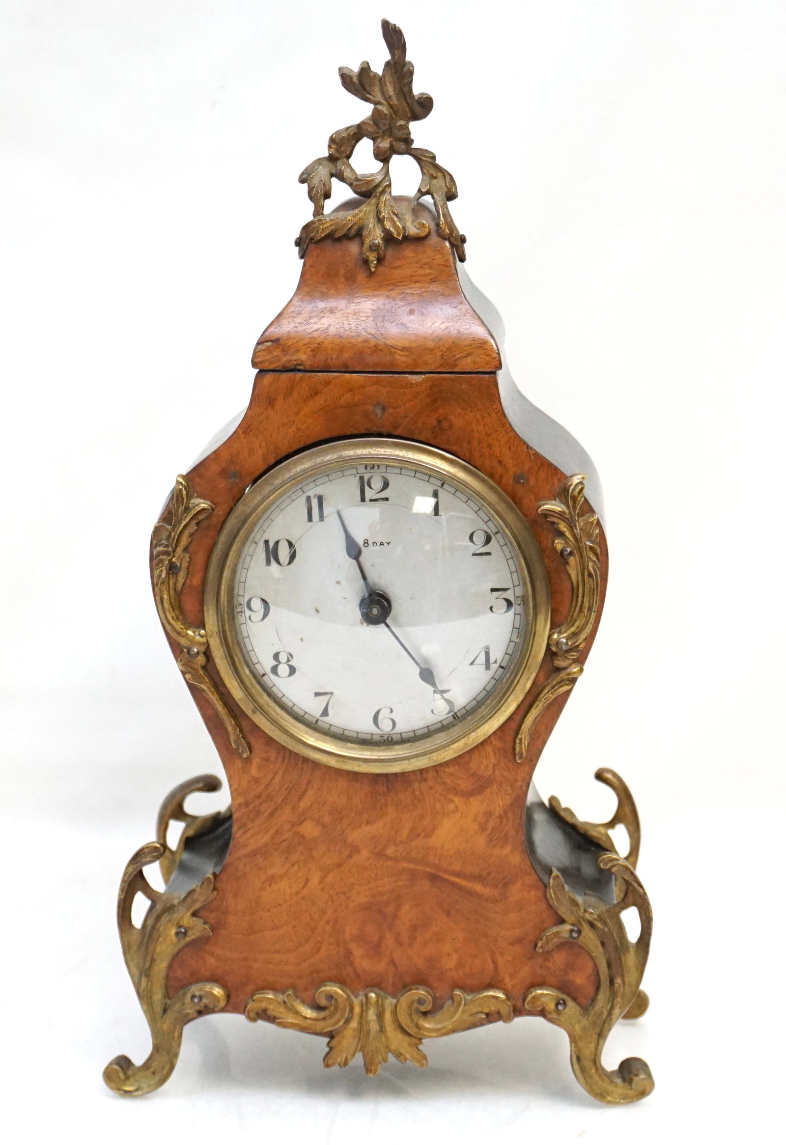 FRENCH CLOCK WOOD BRONZE MOUNTED: Antique French Wood and Bronze Mounted Eight Day Mantle Clock. Rococo style waisted clock with black lacquered sides, burl front. Clock runs when wound but is tested for timekeeping or guaranteed. Mea